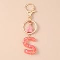 Detail eines rosa Quasten-Schlüsselanhängers mit Harzbuchstaben S und glänzenden Pailletten - Glitzer Buchstabe S