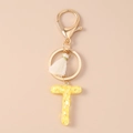 Close-up of letter T sequin keychain with white tassel and gold lobster clasp - Glitter Letter T