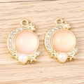 Detail of moon-shaped gold pendants with pink opal gemstones and pearl drops - Gold-Pink