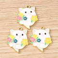 Detailed view of three enamel flower cat charms on a light wood background for DIY jewelry - 10 Pieces Pack / Cat with Flowers