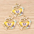Detailed close-up of butterfly wreath charms with rhinestones on a natural wooden background - 10 Pieces Pack / Yellow Butterfly Wreath