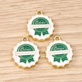 Macro detail of round white and green enamel beer cap pendants with golden metal edges - 10 Pieces Pack / Beer Bottle Cap
