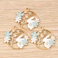 Macro view of three gold-plated rabbit and cherry blossom enamel pendants on wood - 10 Pieces Pack / Blue Flower Rabbit Ring