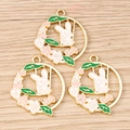 Three enamel bunny pendants with cherry blossoms and swings on a wooden surface - 10 Pieces Pack / White Rabbit Flower Ring