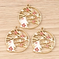 Three enamel rabbit and cherry blossom charms on a light wood background for DIY jewelry - 10 Pieces Pack / Red Ring Plum Blossom