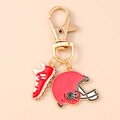 Detalle de llavero de casco y zapato de rugby con esmalte rojo y blanco en metal dorado - Rojo