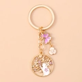 Detailed view of golden ring keychain with cat sakura pendant and purple butterfly charm - Purple Cat Flower