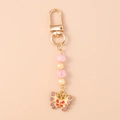 Détail d'un porte-clés papillon avec perles roses, strass et fermoir doré poli - Papillon Jaune