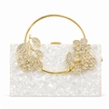Detailed macro view of white acrylic floral evening clutch with golden ring handle - White Shell