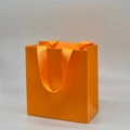 Minimalist bright orange paper gift bag with matching grosgrain ribbon handle - Orange Tote Bag; 14*15*7cm