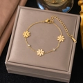 Golden stainless steel bracelet with three daisy pendants and sparkling cubic zirconia crystals - Triple Daisy Bracelet (E2057)