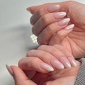Close-up of long almond-shaped fake nails with nude pink ombre gradient and glossy finish - Cdj-20-36