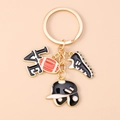 Detailed close-up of rugby themed keychain with gold LOVE charm and sports pendants - Black Baseball Helmet