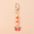 Detail of beaded keychain with gold lobster clasp, pearls and red crystal butterfly charm - Red Butterfly