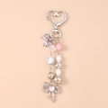 Detailed view of beaded keychain featuring pink pearls, heart lock and silver bow charms - Double Bow Pearl Style (Silver)