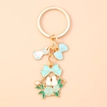 Detail of flower bunny keychain featuring blue enamel bow and cat charms on gold link - Blue Bowknot Rabbit