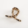 Detail of cross-loop acetate hair claw clip with tortoise leopard pattern and gold spring - Medium Large / Tortoise