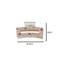 Detailed view of polka dot acetate hair claw clip with dimensions 8.5cm by 4cm - Caramel color