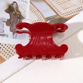 Glossy red acetate hair claw clip with vintage triomphe design on textured background - Crown Style (7.5cm)