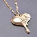 Detailed view of heart pendant necklace with gold lava flow effect and mirror polish finish - Necklace / Gold