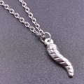 Macro detail of silver stainless steel chili pendant with intricate spiral texture and chain - Silver Necklace