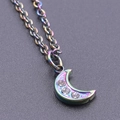 Macro view of iridescent 18K gold crescent moon pendant with three inlaid zircons - Rainbow Color + Necklace Chain
