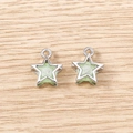Detail of silver five-point star pendants with green resin inlay on wood background - 5 Pieces / Silver Green