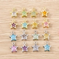 Colorful star charms with gold and silver frames on wood background for DIY jewelry making - 5 Pieces / Multicolor