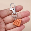 Detailed close-up of a realistic waffle food pendant with a silver lobster clasp keychain - Silver Triangle Bread