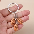Detailed view of creative baguette bread charms on a silver metal keychain ring - Silver Triple Bread