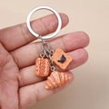 Macro detail of realistic bread keychain featuring waffle, bear cookie, and croissant - Silver Bear Bread