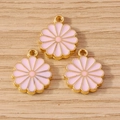 Pink daisy flower pendants with gold plating for DIY jewelry making on wood background - Pink