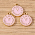 Detailed view of three pink enamel clock pendants with golden Roman numerals on wood - 10 Pieces Pack / Pink