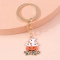 Detailed close-up of a Halloween pumpkin and ghost keychain with Wicked text on gold metal - Ghost Pumpkin
