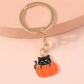 Detail of Halloween pumpkin cat keychain with gold ring and metallic enamel charm - Black Cat in Pumpkin