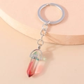 Detail shot of a gradient crystal hexagonal column keychain with silver metal ring - Crimson