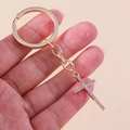 Detailed close-up of a golden keychain featuring a cross pendant encrusted with rhinestones - Gold Full Zircon Cross