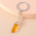 Detail showing amber hexagonal crystal pendant and polished silver metal keychain ring - Amber