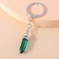 Detailed macro view of dark green hexagonal crystal pendant on polished silver keychain - Dark Green