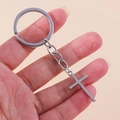 Detail view of a silver-toned rhinestone cross keychain held in hand for scale - Silver Full Zircon Cross
