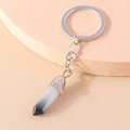 Macro view of a minimalist hexagonal crystal pillar keychain with silver metal chain - Black and White