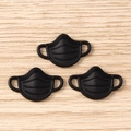 Detailed macro view of 3D black mask-shaped pendants for DIY jewelry and crafts - 10 Pieces Pack / Black Mask