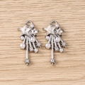 Detailed shot of Y2K star pendant with rhinestones and white pearls on wooden surface - Silver