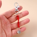 Detail view of handmade silver fish pendant with red stone beads and lobster clasp - Red Stone Small Fish