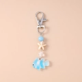 Detail view of ocean-themed keychain with starfish and clownfish charm on silver hook - Blue Starfish Clownfish