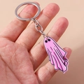 Close-up of a pink ghost Halloween keychain with a silver metal ring held by a hand - Ghost