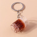Macro detail of a creative mini beer mug keychain with realistic foam and dark liquid - Stout