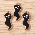 Detailed macro view of black enamel ghost charms with gold plating on light wood surface - 10 Pieces Pack / Black Big Ghost