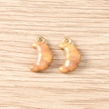 Detailed macro view of croissant-shaped resin charms with gold metal rings for DIY jewelry - 5 Pieces / Croissant
