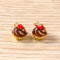 Macro detail of chocolate cupcake charm with brown enamel and red berry accent on gold base - 5 Pieces / Black Cake